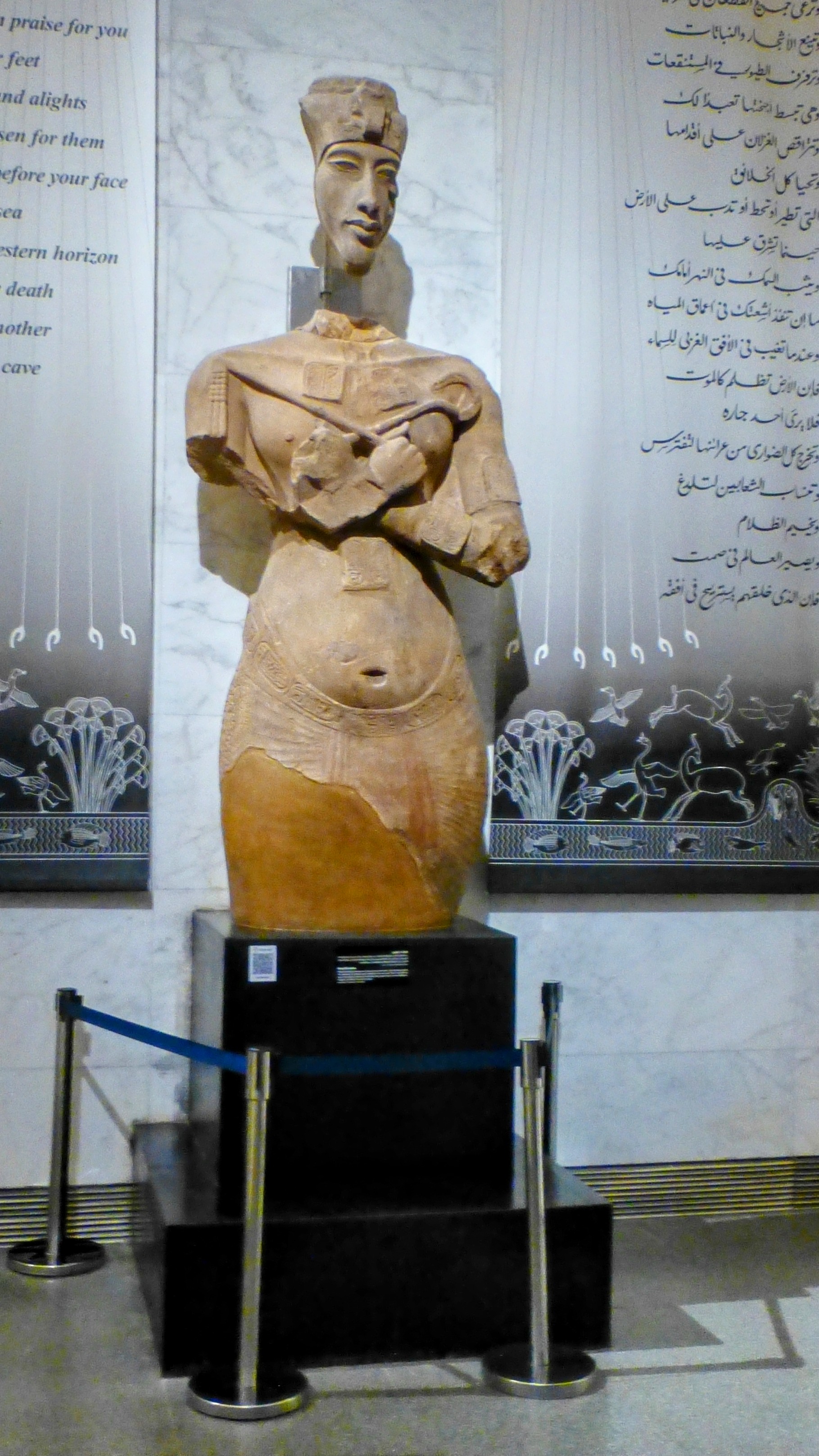 This statue of King Akhenaten showcases the unique Amarna art style with his elongated features, long face, and distinctive royal attire. It was created around 1350 BC.