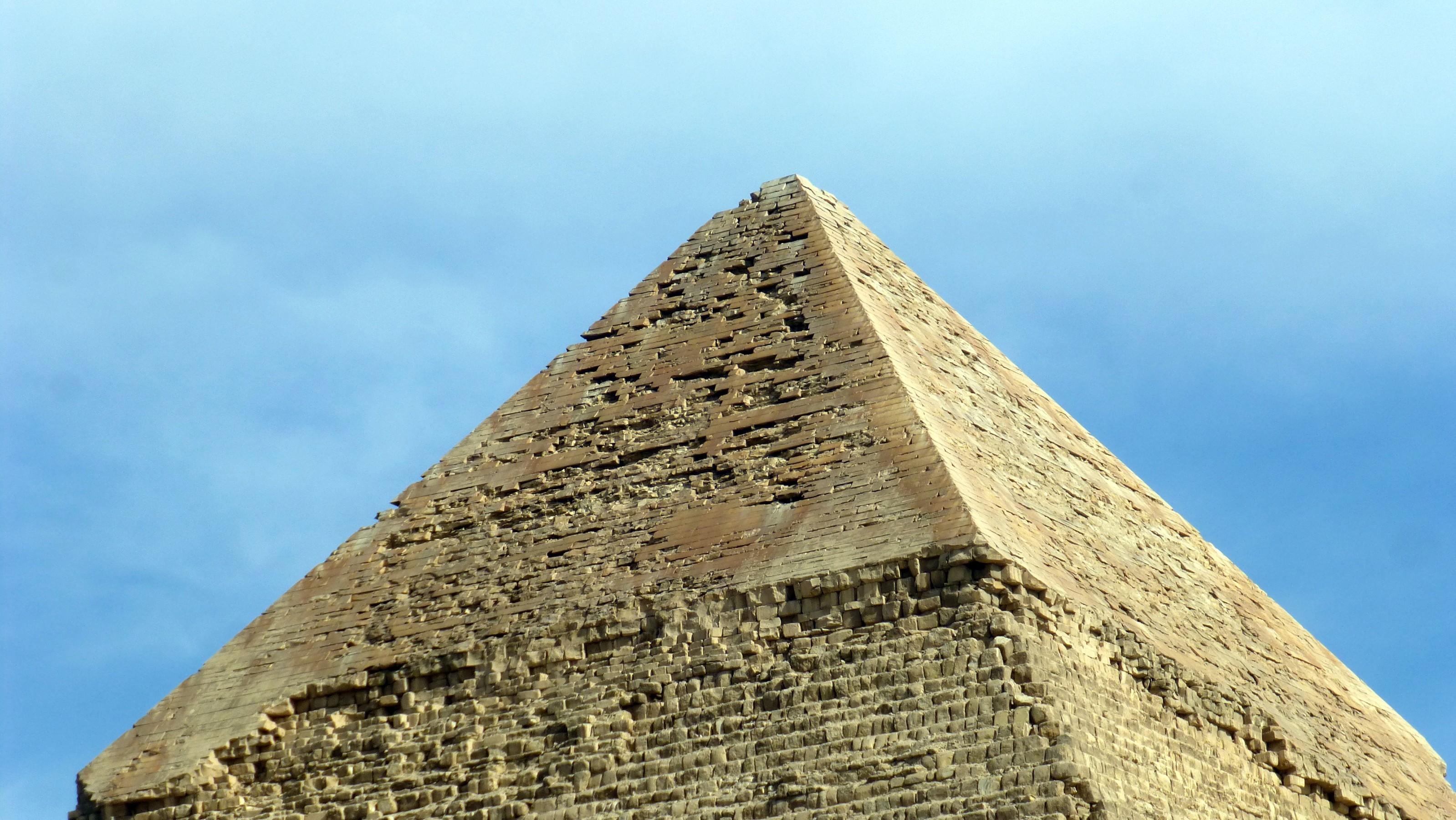 They pyramids were constructed with sandstone and orignally overlayed with white limestone casing stones. Unfortunately, over the years most of them have been removed and used on other projects or simpley sluffed off of the sides. The cap of the Pyramid of Khafre still retains some of the original limestone offering a glimpse of their original brilliant appearance.