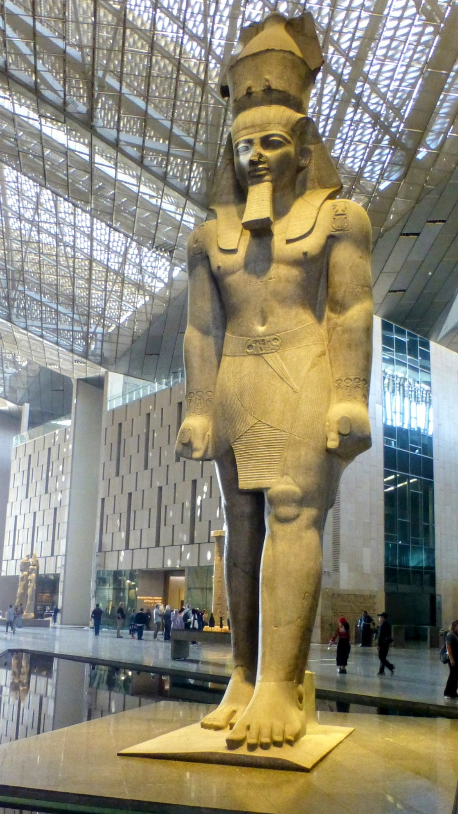 The statue of Ramses II stood on the side of the Grand Egyptian Museum prior to its construction. It now greets all visitors to the museum. He is standing with his hands to his side with his left leg forward, a symbol of his military prowess.