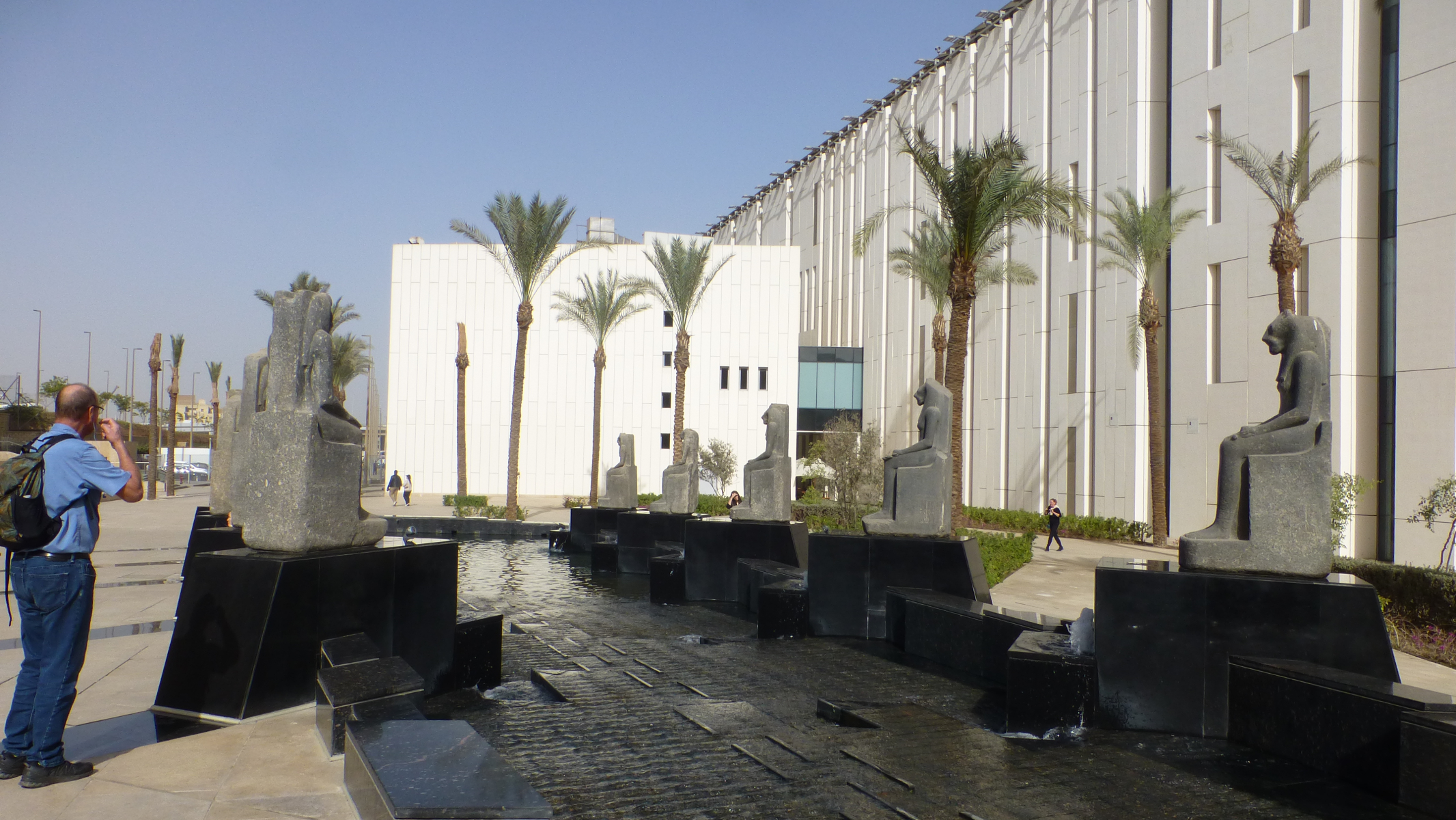 Statues in front of the Khufu Boat Museum. I believe they are of the goddess Bastet.