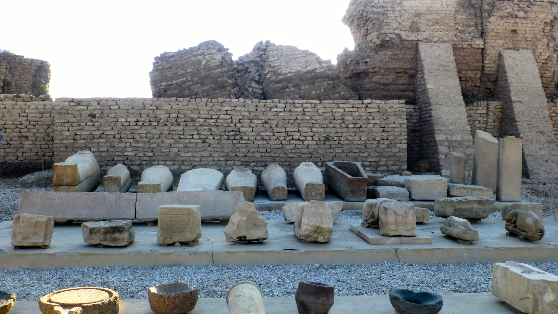 On one side of the avenue leading to the Temple relics are displayed including a lineup of sarcophagi.