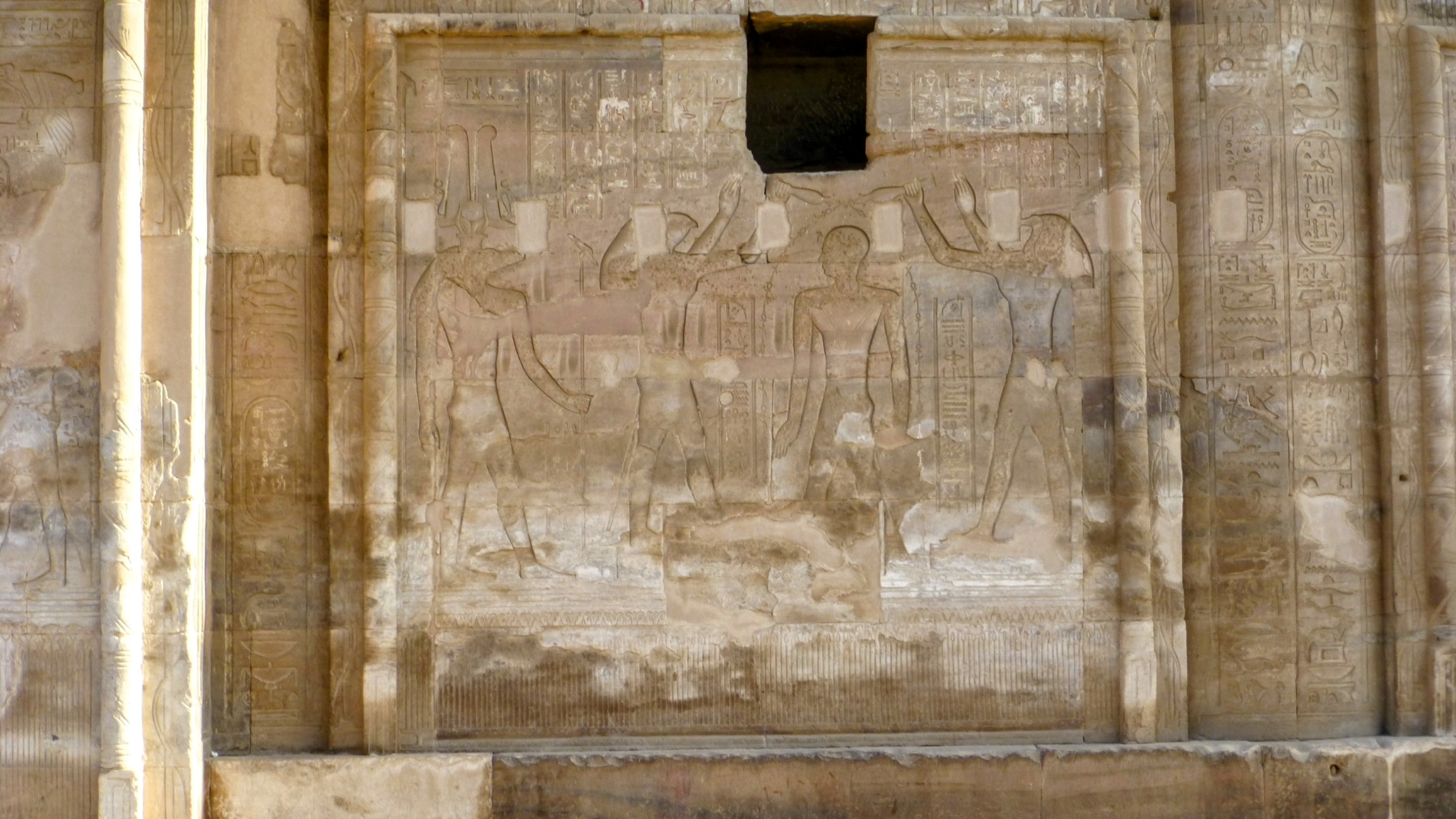 Ptolemy VII is receiving blessings from Horus and Sobek.