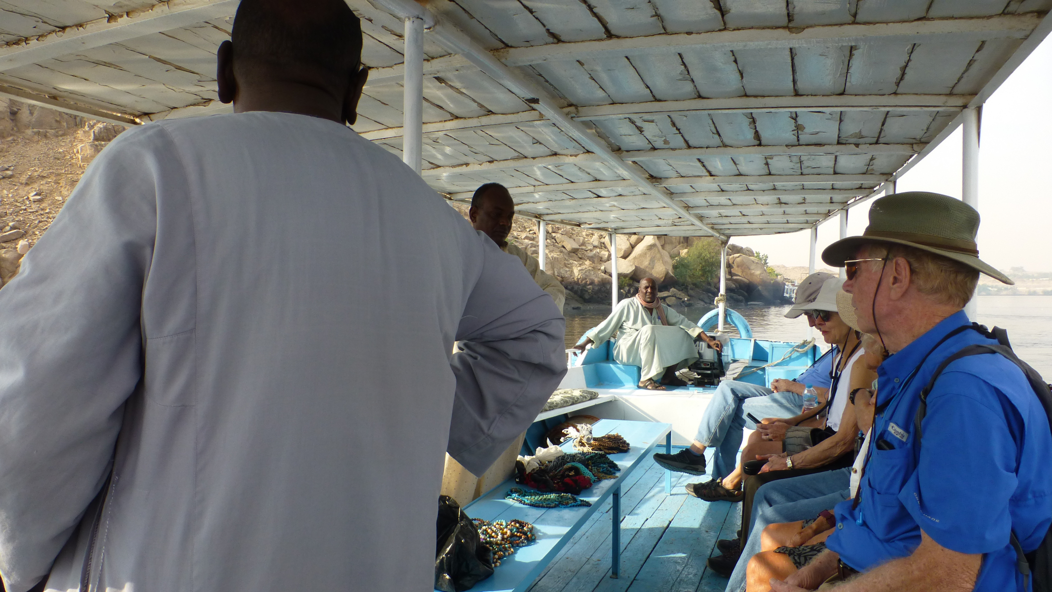 Our captain on the boat returning from our island. Two nubian gents are along selling some of their <q>souvenirs</q>.