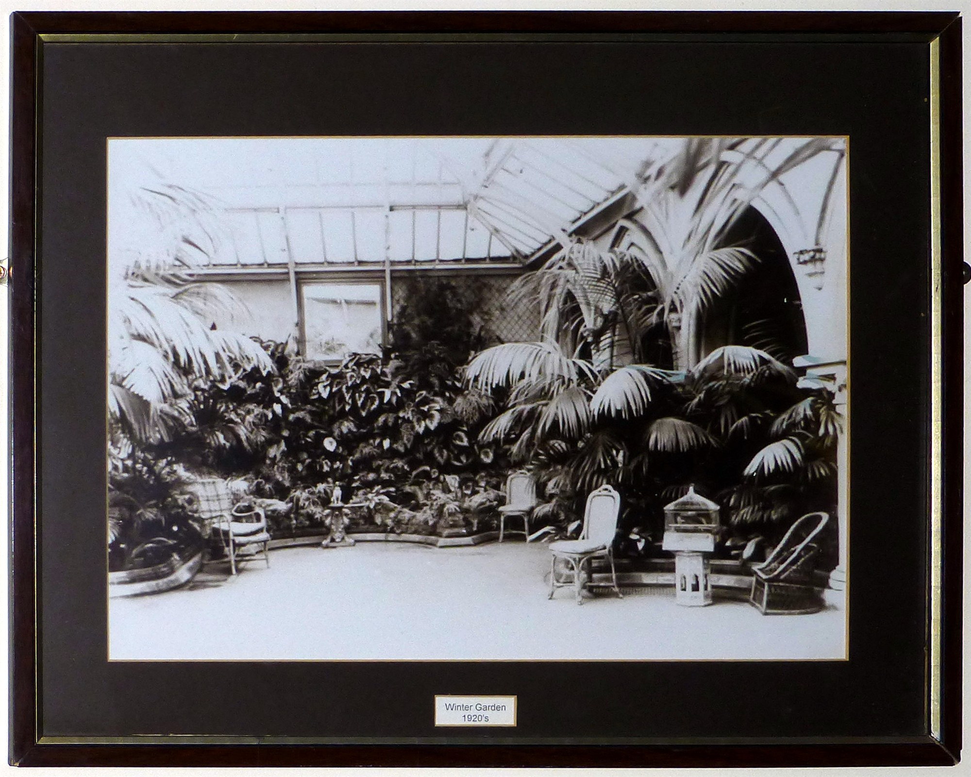 A photograph of the Winter Garden in its heyday hangs on the garden wall. You see the Gothic Arches that served to define the garden area.