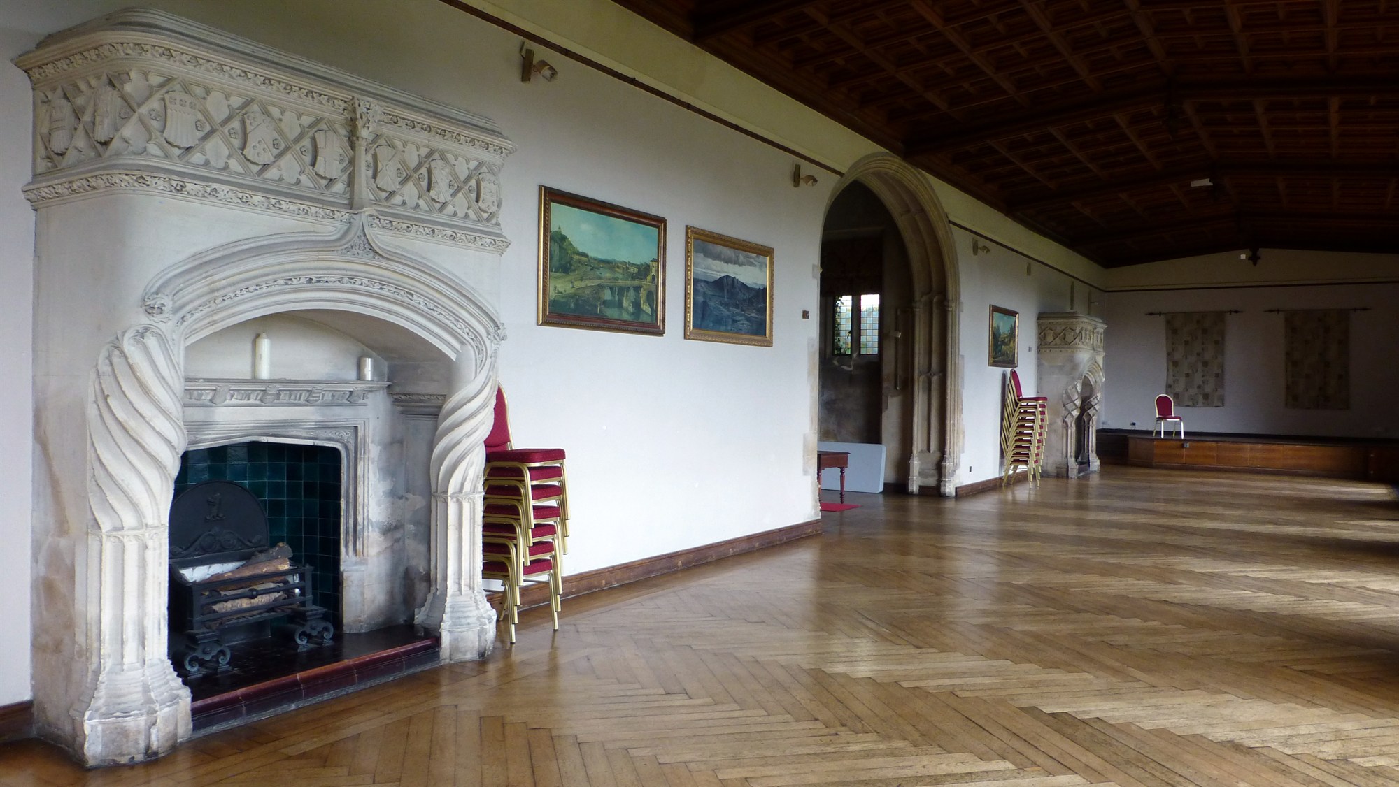 The expansive Music Room with its double fireplaces, barrel ceiling and parquet floor. It would have served as a ballroom back in the day.