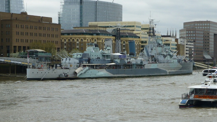 The HMS Belfast lies at anchor on the River Thames, possibly as a backup to the two Jool guards.