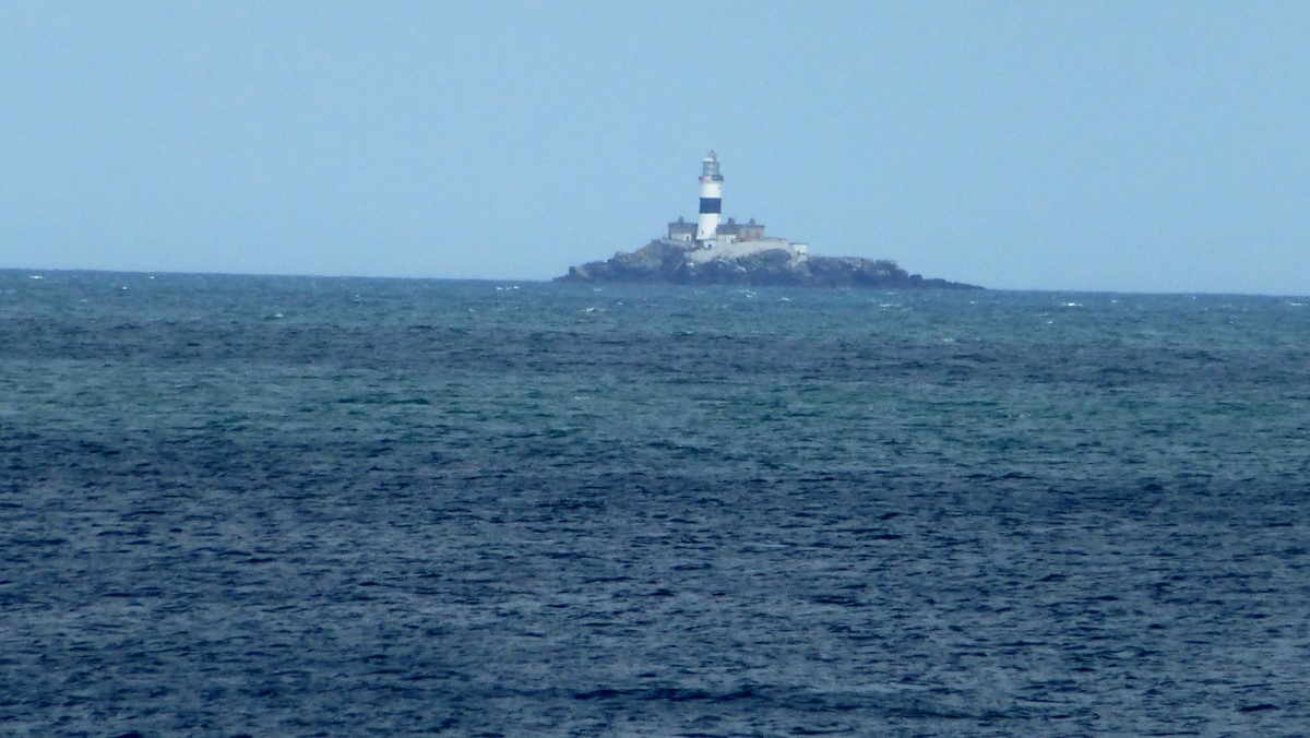 A lighthouse far off in the Mist