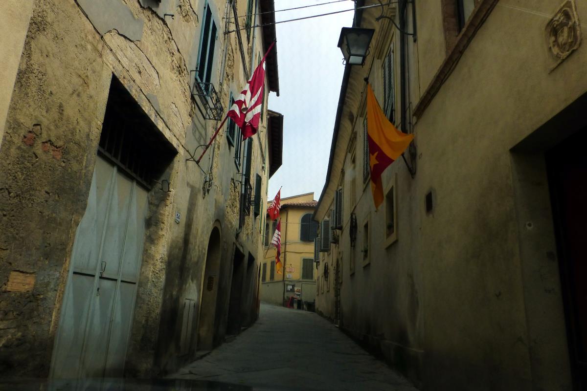 Amy driving through the streets of Montalcino
